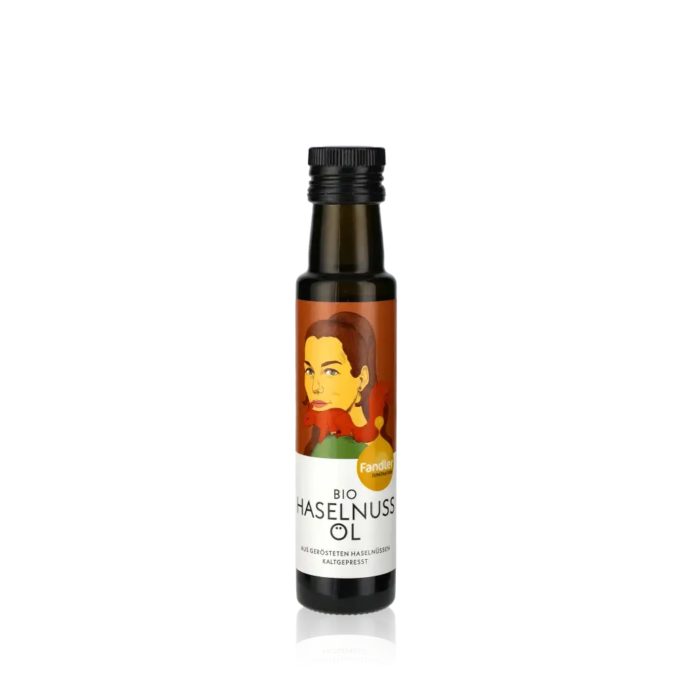 Fandler Bio Haselnussöl Flasche auf schwarzem Hintergrund.