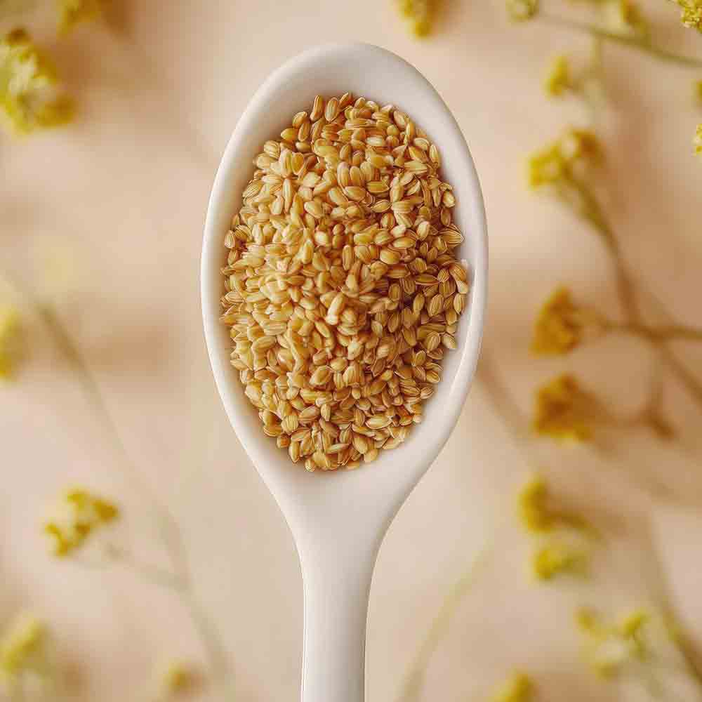 Löffel mit Camelina-Samen, umgeben von gelben Blüten.