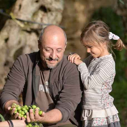Mann und Kind mit Oliven.