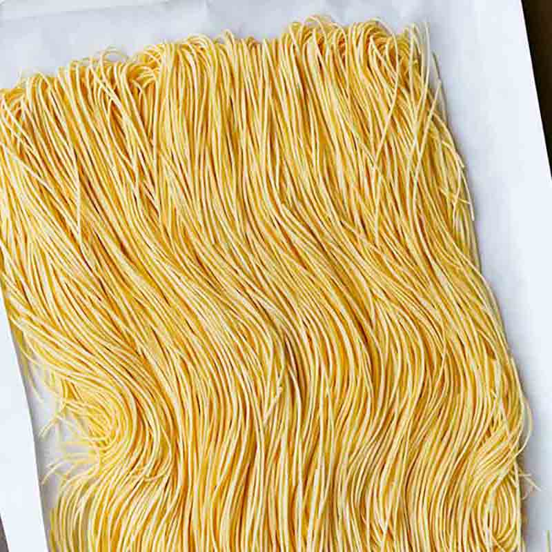 Frische gelbe Spaghetti auf Tablett.