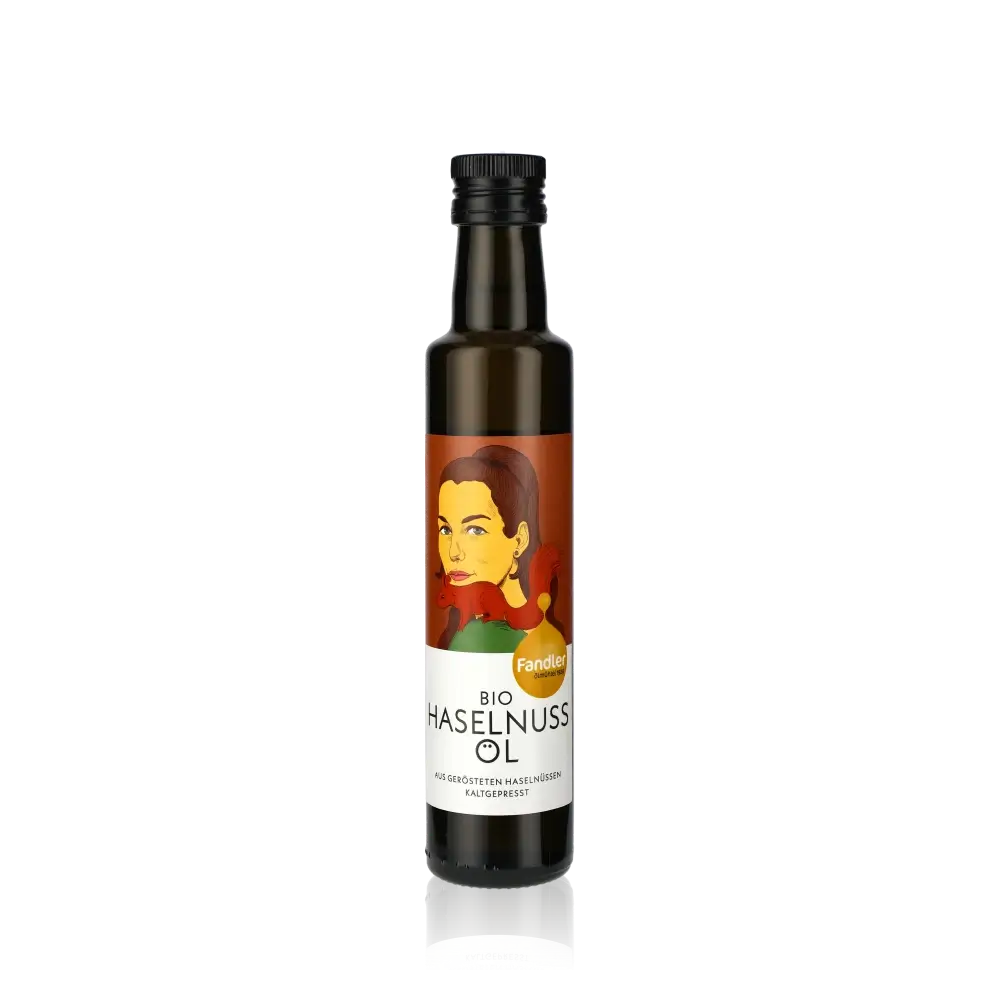 Fandler Bio Haselnussöl Flasche auf schwarzem Hintergrund.