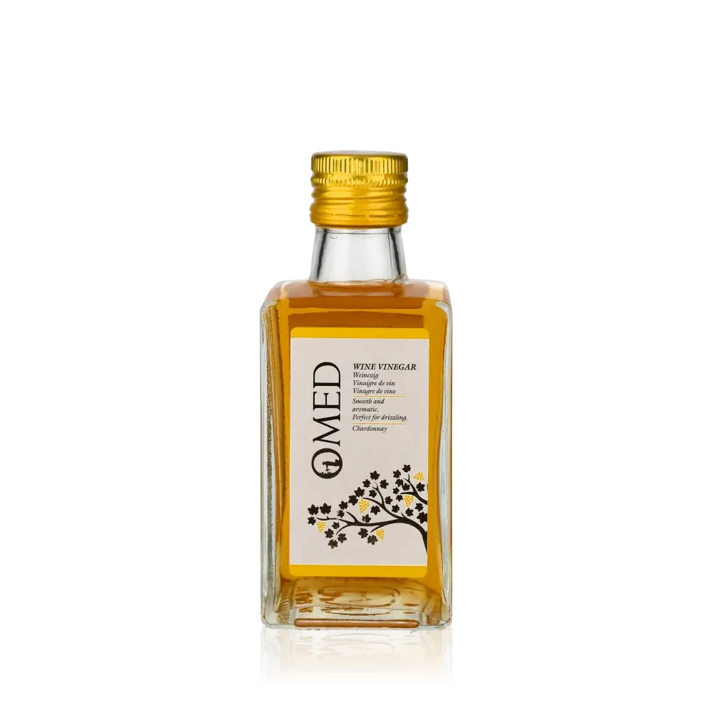 O-MED Chardonnay Weißweinessig Flasche vor schwarzem Hintergrund.