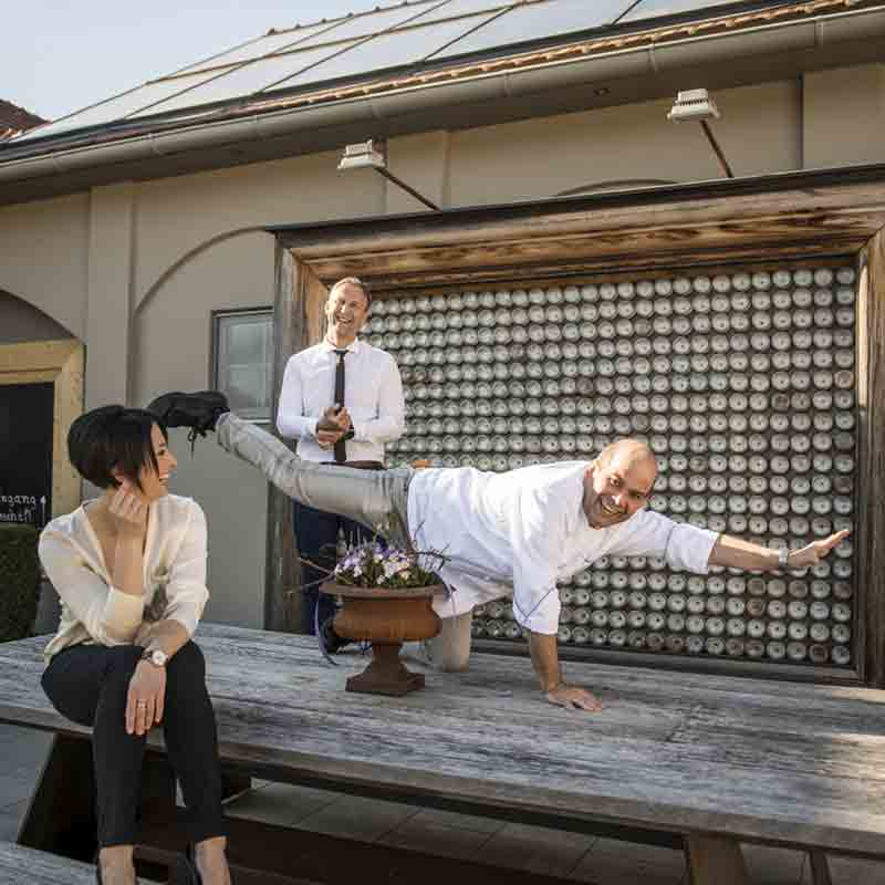 Bettina Fink-Haberl und Hans Peter Fink sitzen auf der Terrasse des Spitzenrestaurants und sind fröhlich.