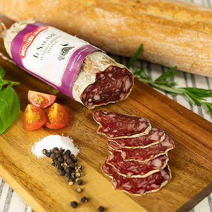 Salami, Baguette, Tomaten, Pfeffer, Salz auf Holzbrett.