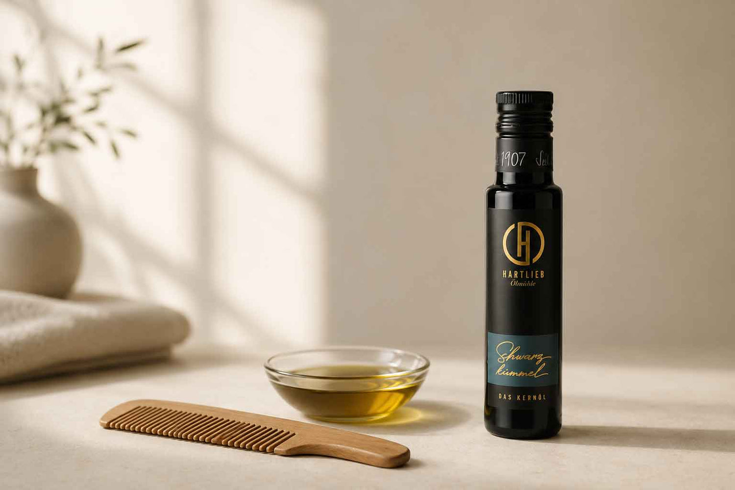 Schwarzkümmelöl steht neben einem Kamm für die Haare