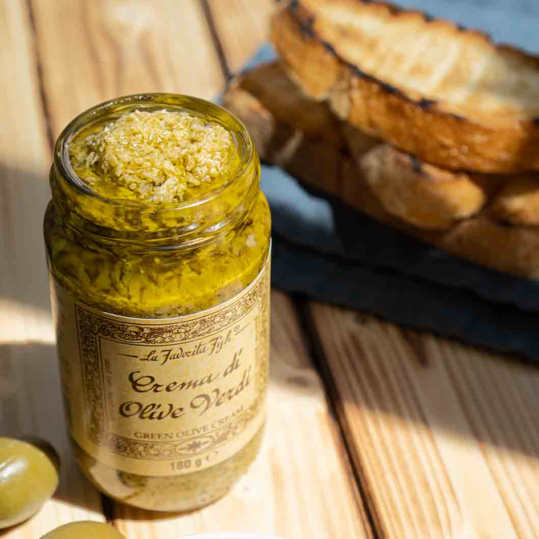 La Favorita Feinkost: Grüne Olivencreme im Glas mit Brot.