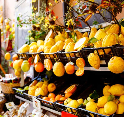 Zitronen und Orangen in Körben auf Marktstand ausgestellt.