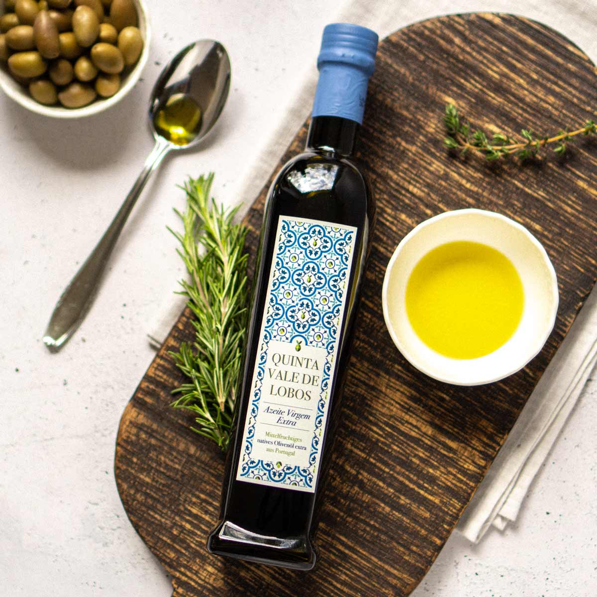 Olivenölflasche Quinta Vale de Lobos mit Kräutern und Schale.